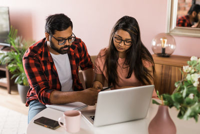 Young woman using laptop at home