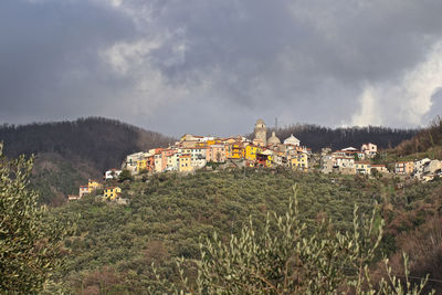 Panoramic view of buildings and mountains against sky