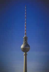 Low angle view of communications tower against sky