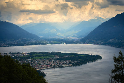 Scenic view of river and mountains against sky