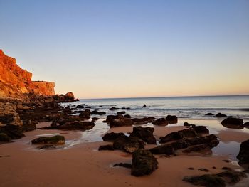 Scenic view of sea against clear sky during sunset