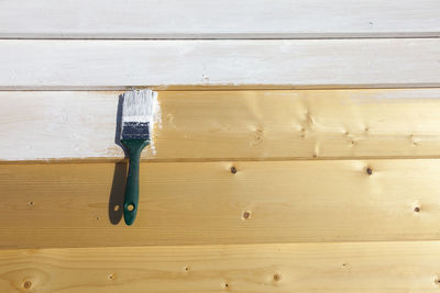 Close-up of paint brush on wood