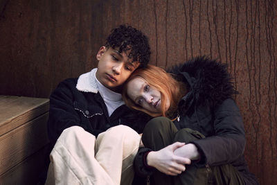 Young woman and boy cuddling and comforting each other