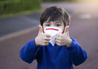 Portrait of boy holding camera