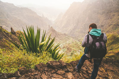 Rear view of man standing on mountain