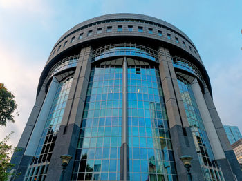 Low angle view of modern building against blue sky