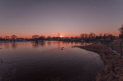 Scenic view of river at sunset