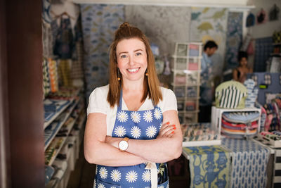 Portrait of a smiling young woman standing in store