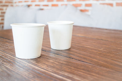 Disposable cups on wooden table