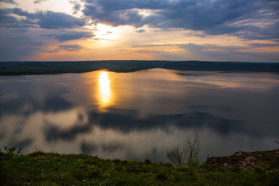 Scenic view of lake against cloudy sky