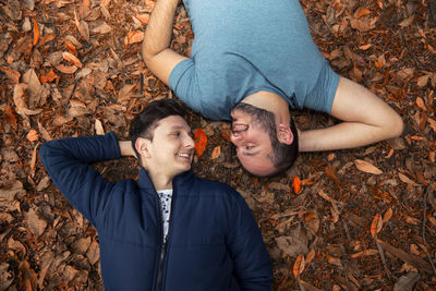 High angle view of gay men lying on field at park