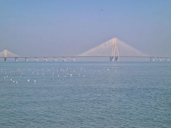 The bandra-worli sea link. suspension bridge over river against clear sky
