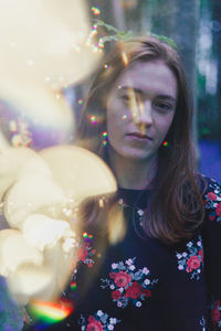 Close-up of young woman with flowers in hair