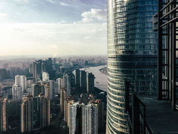 High angle view of cityscape against cloudy sky