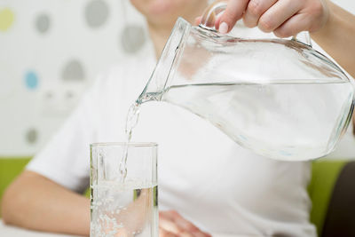 Midsection of woman holding drink