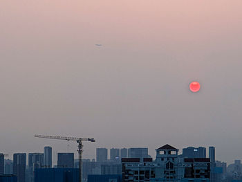 Buildings in city against sky at dusk