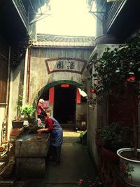 Rear view of man walking on building