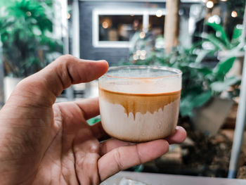 Close-up of hand holding coffee cup