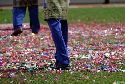 Low section of woman standing on confetti