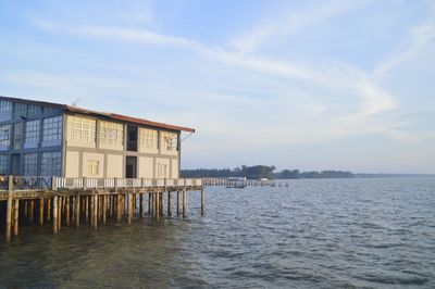 Building by sea against sky