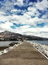 Scenic view of mountains against cloudy sky