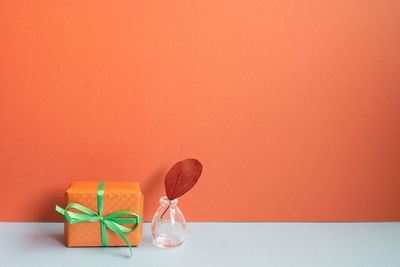 Close-up of christmas decorations against yellow background