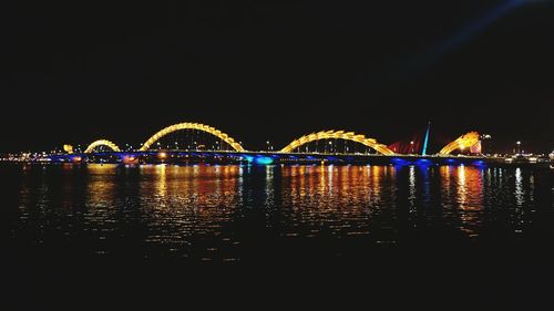 Illuminated cityscape against sky at night