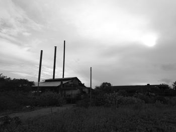 Built structure on field against sky