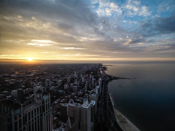 Aerial view of buildings against sky during sunset