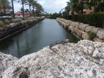Canal amidst rocks against sky