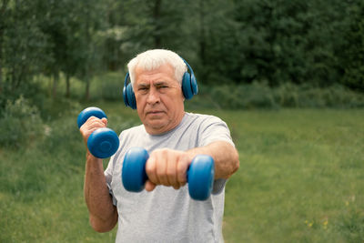 Portrait of young woman exercising in park