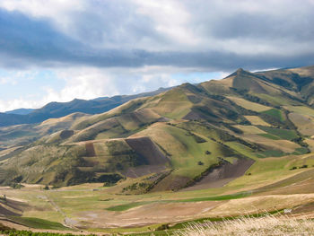 Scenic view of mountains against cloudy sky