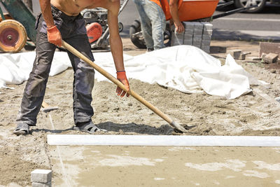 Low section of man working at construction site