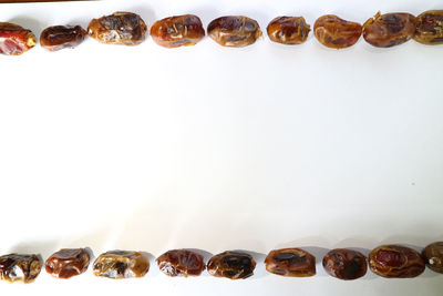 Close-up of coffee beans against white background