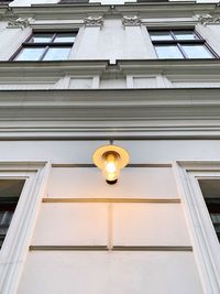 Low angle view of street light against building