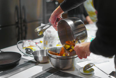 Midsection of man preparing food in kitchen