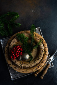 High angle view of christmas decoration over wooden plates on table