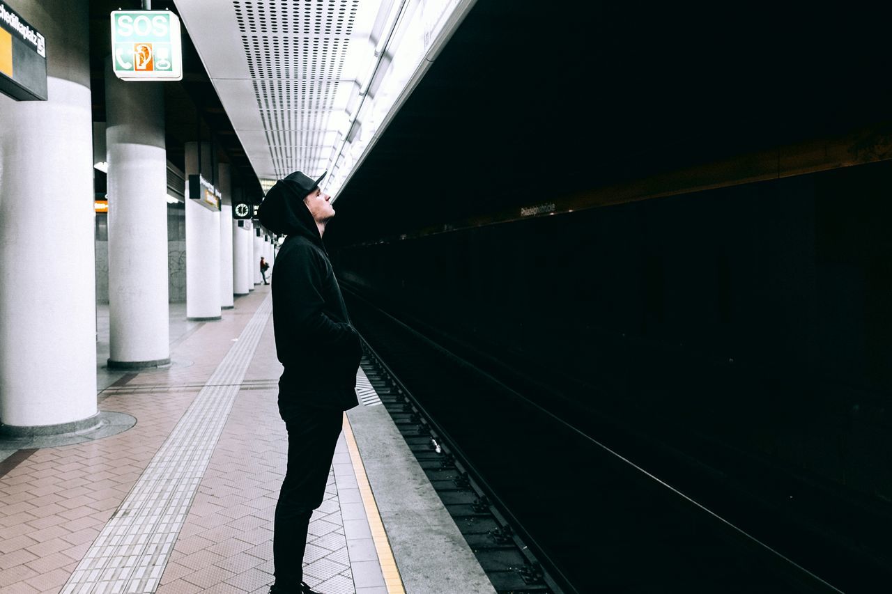 transportation, lifestyles, walking, railroad station platform, railroad station, men, indoors, person, railroad track, architecture, the way forward, rail transportation, rear view, public transportation, built structure, full length, city life, travel