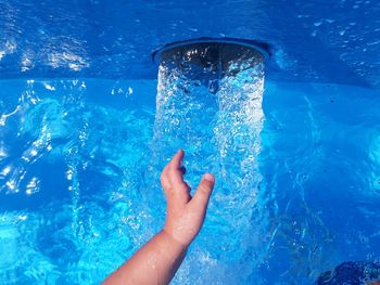 Close-up of person splashing water in swimming pool