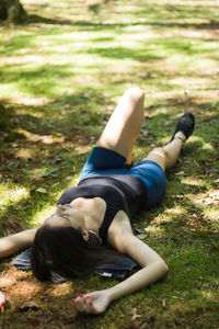 Young woman lying on grass