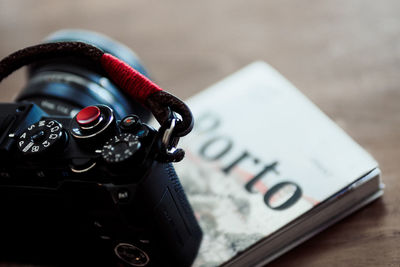 Close-up of camera and book on table