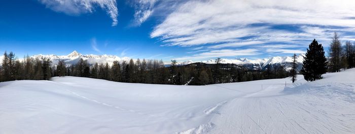 Snow covered landscape against sky