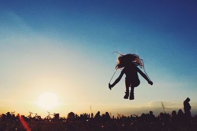 Low angle view of woman against clear sky