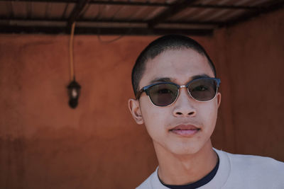 Close-up portrait of young man wearing sunglasses 