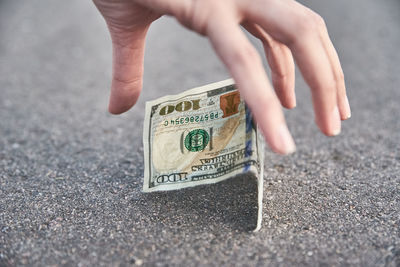 Close-up of hand holding banknote
