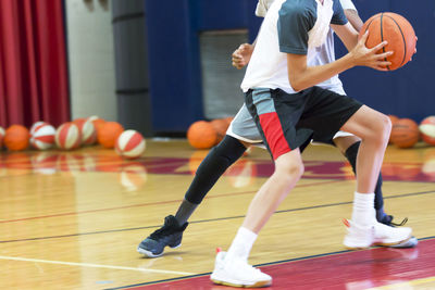 Low section of people playing with ball