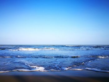 Scenic view of sea against clear blue sky