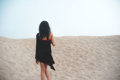 Rear view of woman on sand