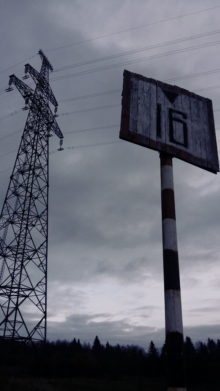 sky, low angle view, field, built structure, fuel and power generation, architecture, cloud - sky, technology, tower, tree, guidance, nature, no people, day, landscape, silhouette, communication, outdoors, wind power, cloud