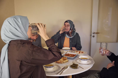 Family drinking water at dinner